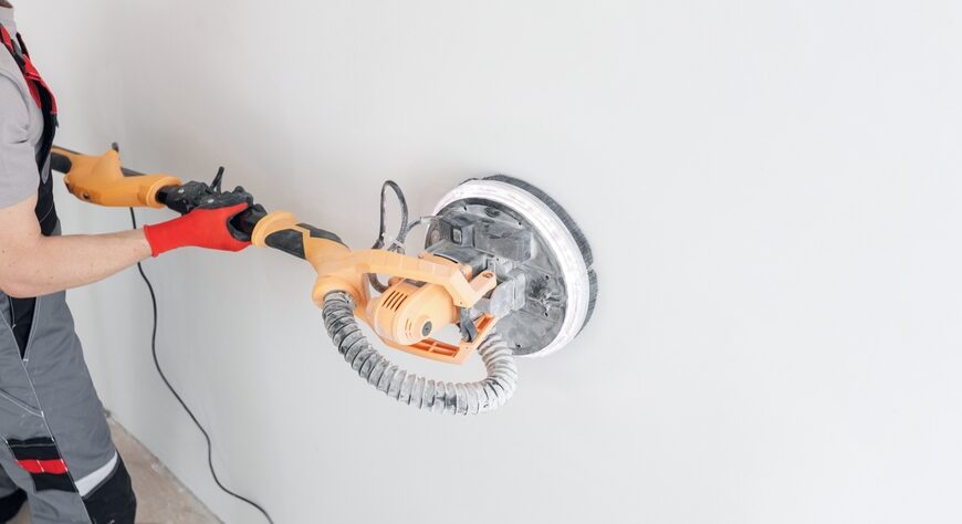 Drywall sander on wall