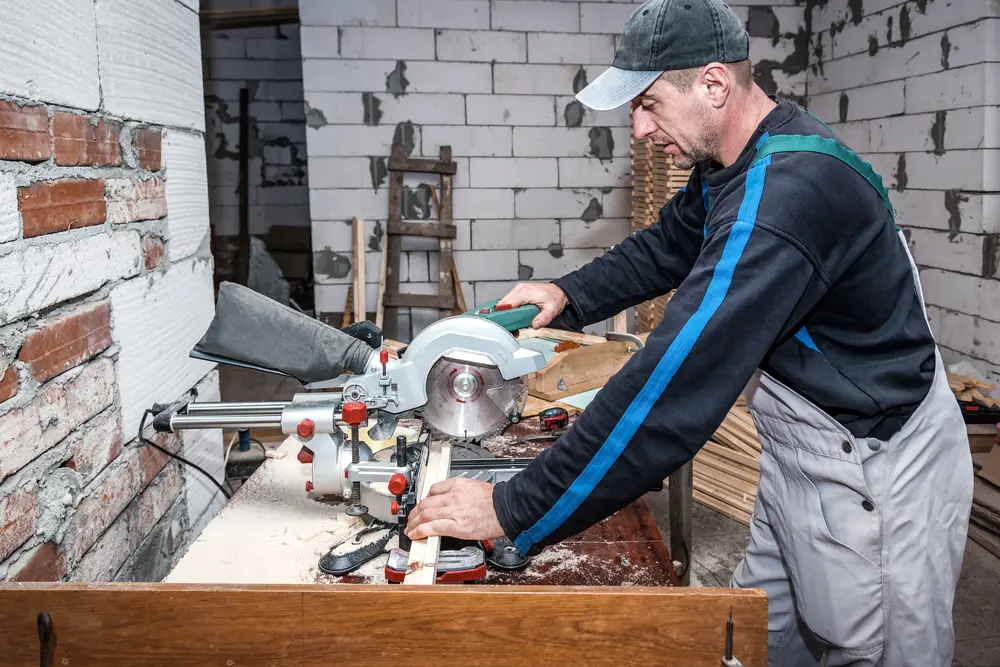 carpenter using mitre saw