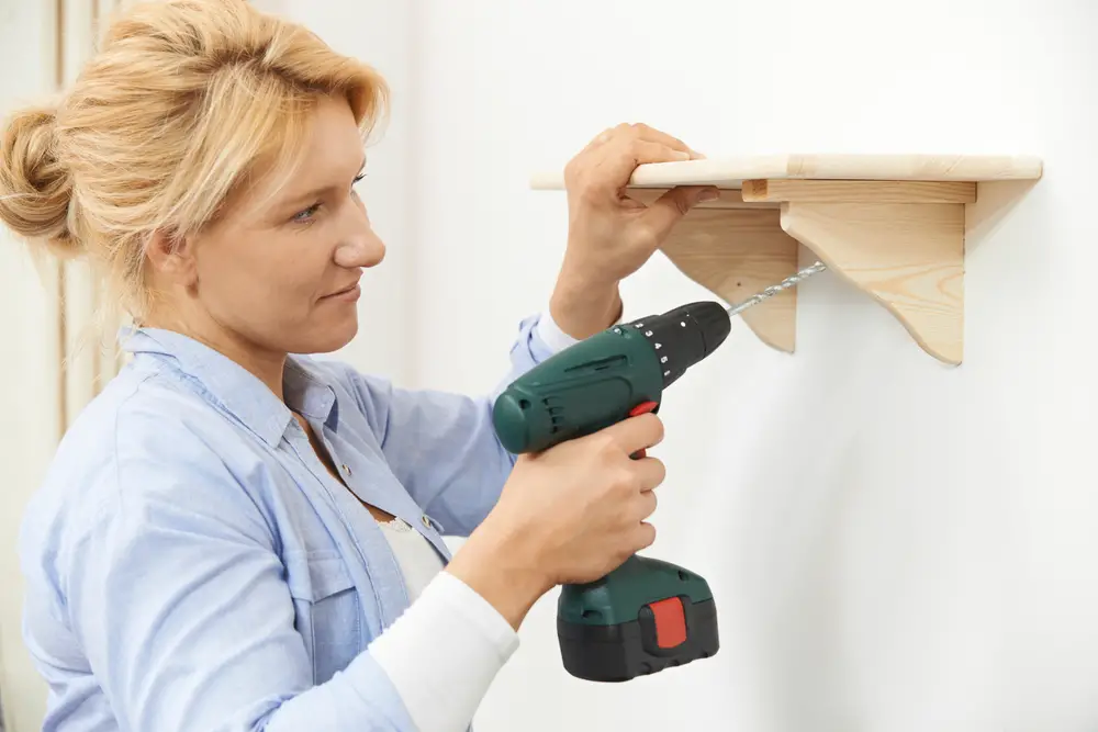 putting up wooden shelf